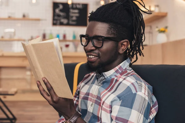 depositphotos_175096612-stock-photo-smiling-african-american-man-reading